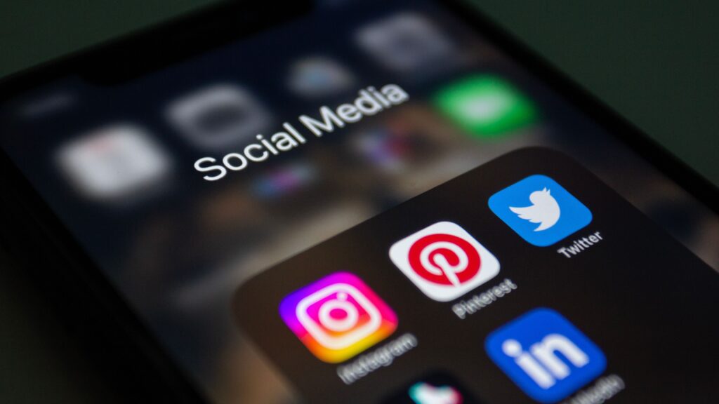 Pinterest Strategy for Affiliate Bloggers: How to Get Free Traffic in 2026 A smartphone screen displaying popular social media applications like Instagram and Twitter.